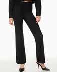 Model wearing Siamo Firenze black Contour Flare Pants, featuring a sculpted high-waist fit and elegant flare, styled with black pointed heels.