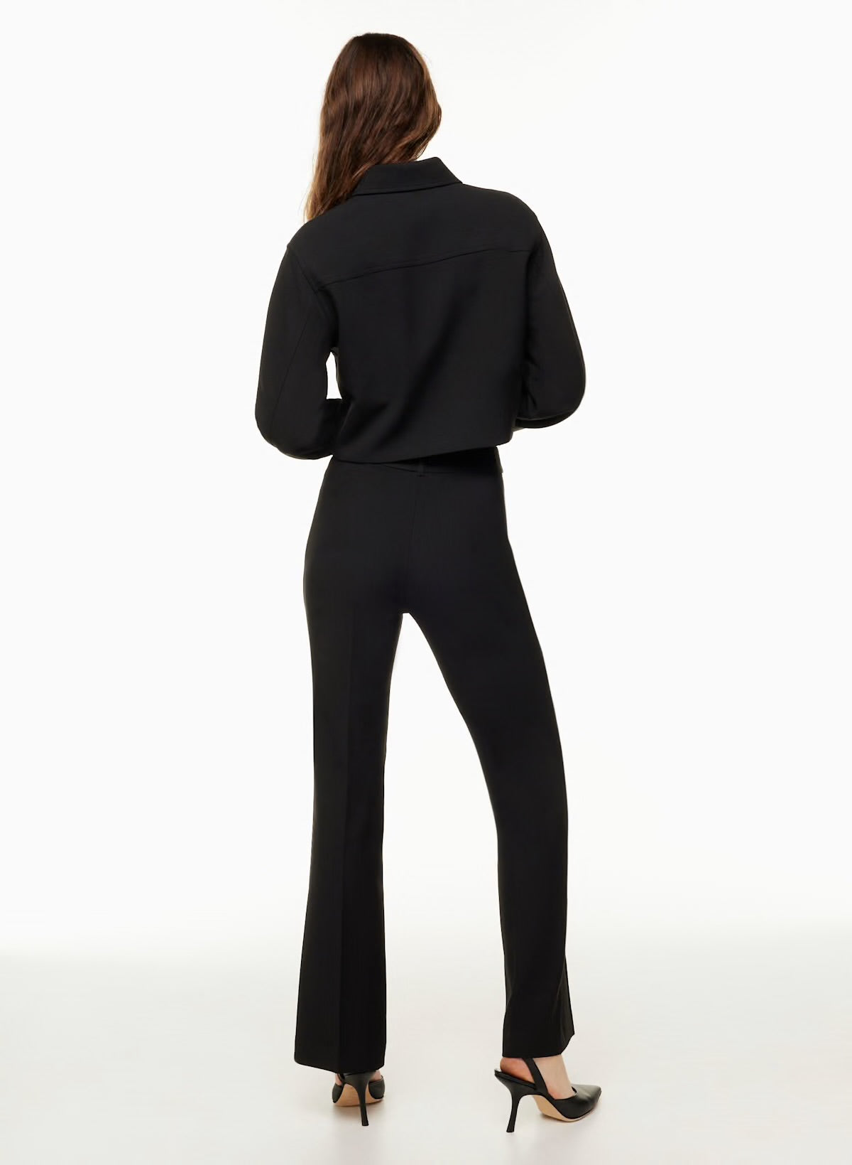 Back view of Siamo Firenze black tailored pants, designed to contour the body and elongate the silhouette with a flattering flare cut.