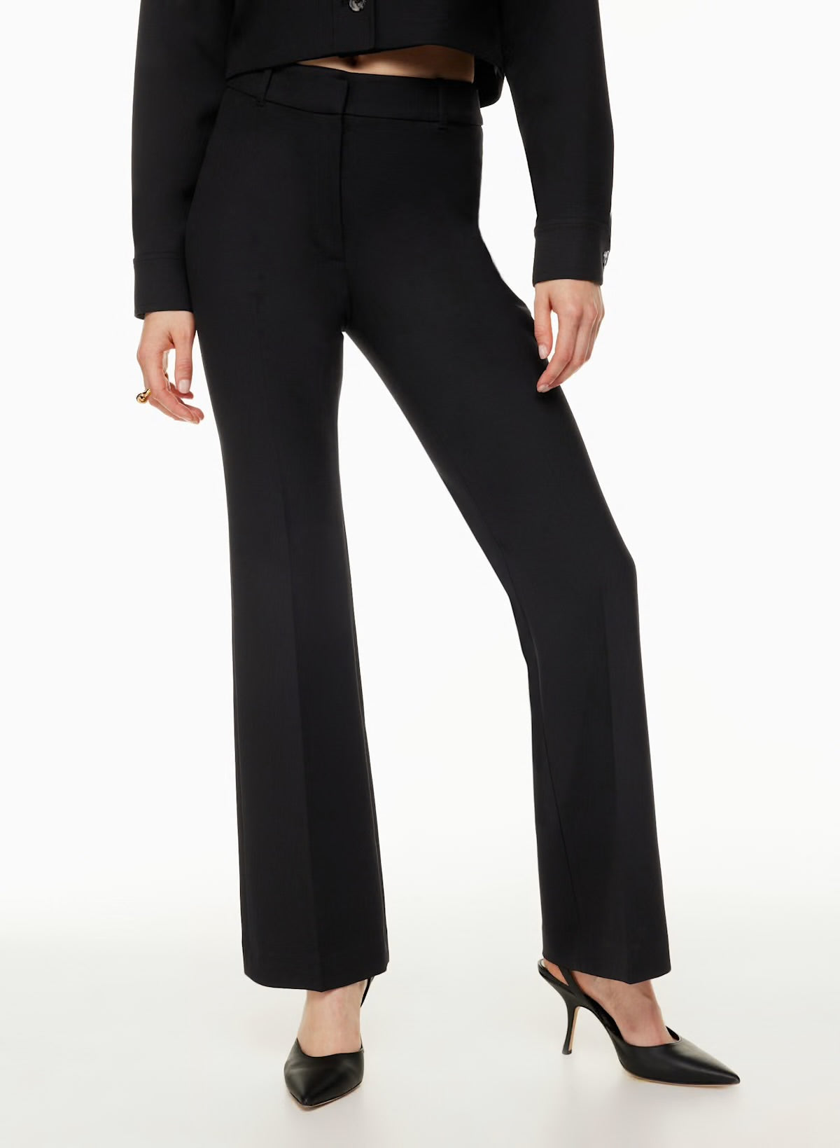 Model wearing Siamo Firenze black Contour Flare Pants, featuring a sculpted high-waist fit and elegant flare, styled with black pointed heels.